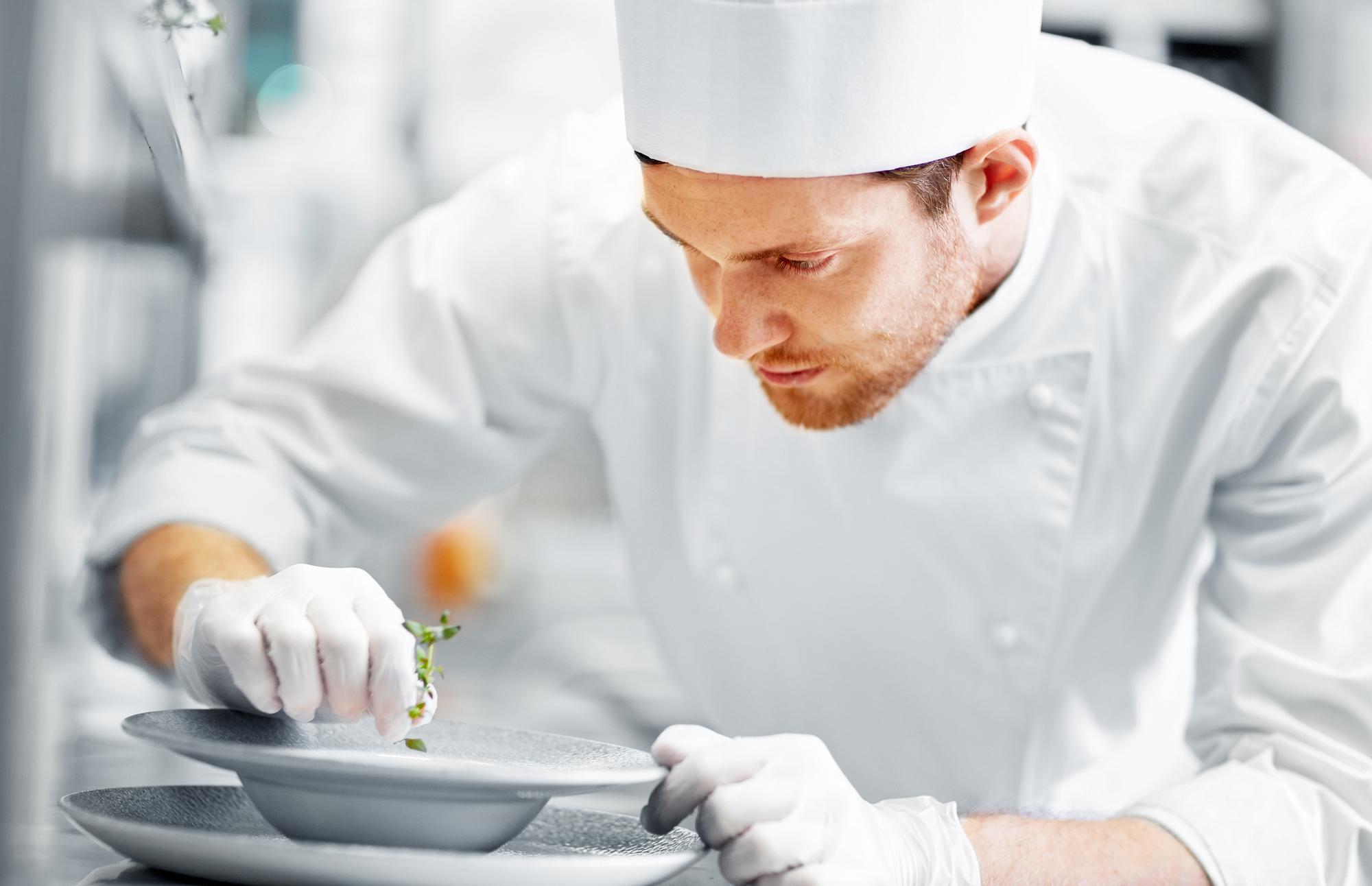 Laboratory chef preparing plated dishes